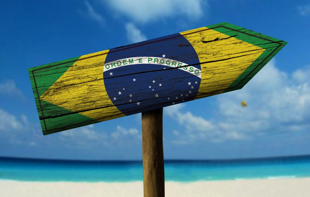 Brazil flag wooden sign with a beach on background