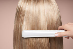 hairdresser straightening long hair with hair iron HXBL426 Easy Resize.com 